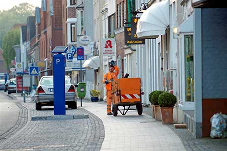 Alle die früh zur Arbeit gehen, oder von der Arbeit auf dem Weg nach Hause sind, dann die Walker und Jogger, Herrchen mit Hund, die Fahrer der LKW der Bäckereien und viele andere Lieferanten – man kennt sich, man grüßt sich und immer ein nettes Wort von unseren Männern in Orange. 