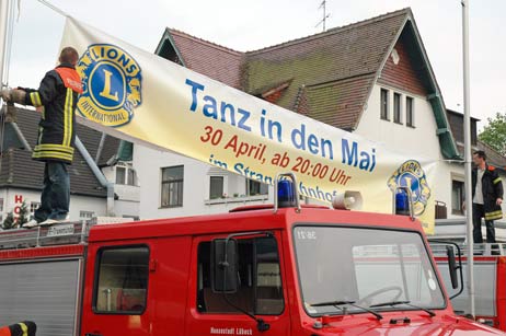 Die FFW Travemünde brachte das Banner zum »Tanz in den Mai« im Strandbahnhof in der Bertlingstraße an. Foto: TA